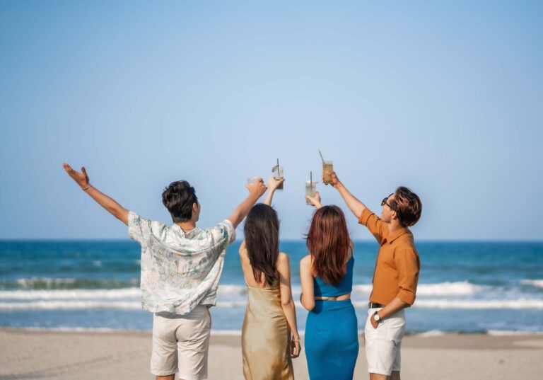 Friends enjoying drinks on the beach