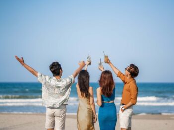 Friends enjoying drinks on the beach